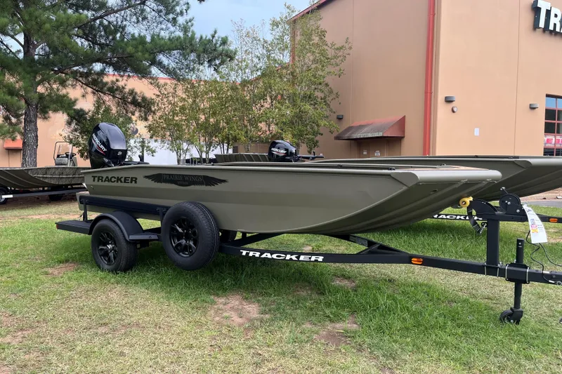 The Image of 2026 Tracker Grizzly 1650 T Prairie Wings Edition boat on trailer, parked outdoors. - 0