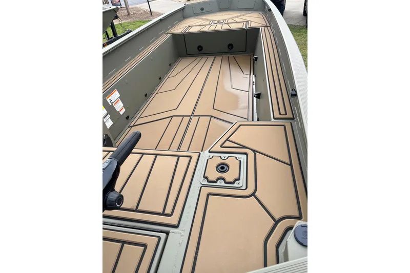 Slide: The Image of 2026 Tracker Grizzly 1650 T Prairie Wings Edition boat interior with tan deck design. - 2