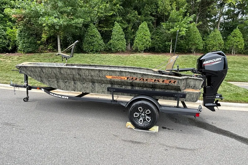 Slide: The Image of 2026 Tracker Grizzly 1756 T Marsh boat on trailer, parked on a road. - 4