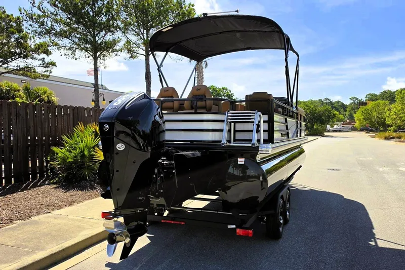 Slide: The Image of 2026 Ranger 223FC pontoon boat with outboard motor on a sunny street. - 5