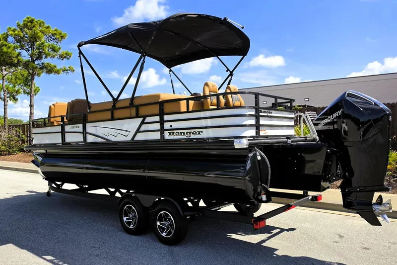 Slide: The Image of 2026 Ranger 223FC pontoon boat with canopy and Mercury outboard motor on trailer. - 12