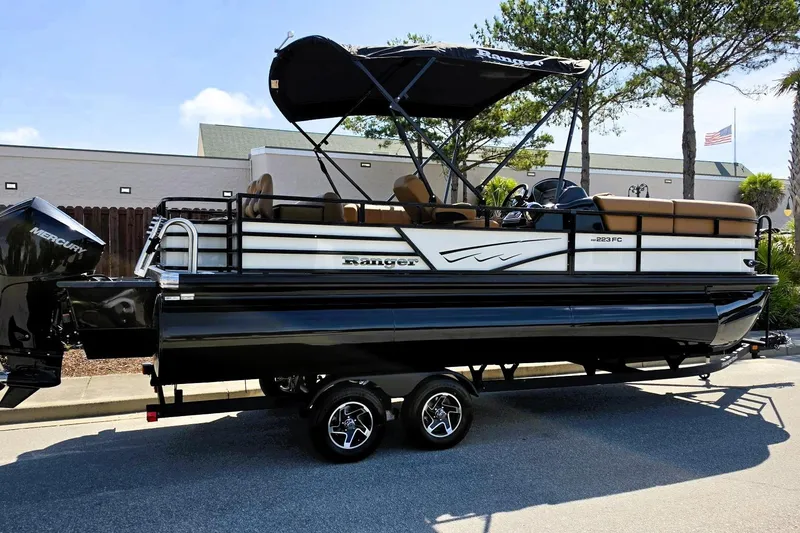 The Image of 2026 Ranger 223FC pontoon boat with Mercury engine, parked outdoors. - 0