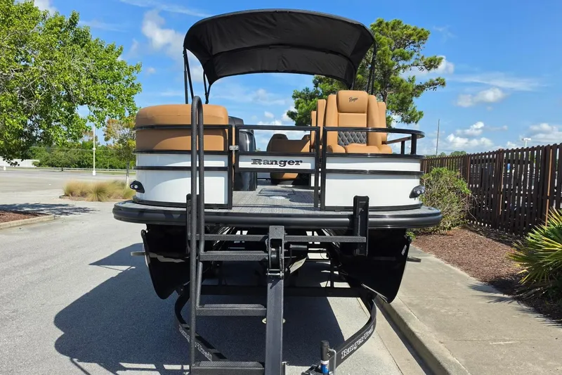 Slide: The Image of 2026 Ranger 223FC boat on trailer, parked outdoors under clear blue sky. - 9