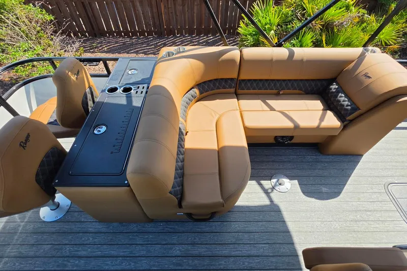 Slide: The Image of Luxurious seating on 2026 Ranger 223FC boat with tan upholstery and console. - 18