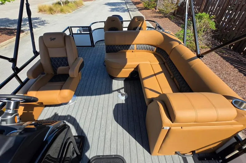 Slide: The Image of 2026 Ranger 223FC boat interior with tan seating and modern design. - 17