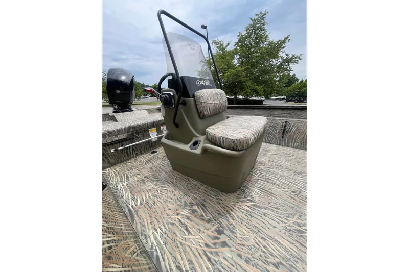 Slide: The Image of 2026 Tracker Grizzly 2072 CC with a central console and camouflaged seating. - 6