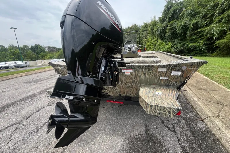 Slide: The Image of 2026 Tracker Grizzly 2072 CC boat with powerful Mercury outboard engine, parked outdoors. - 4