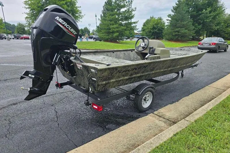 Slide: The Image of 2026 Tracker Grizzly 1648 SC boat on trailer with Mercury outboard motor in parking lot. - 3