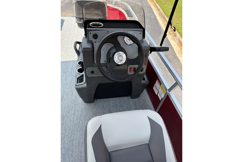 Slide: The Image of 2026 Sun Tracker Bass Buggy 16 XL Select boat console with steering wheel and seating. - 2