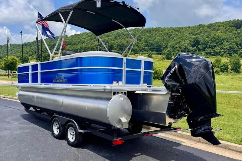 Slide: The Image of 2026 Sun Tracker Party Barge 22 XP3 pontoon boat with Mercury engine on trailer. - 4