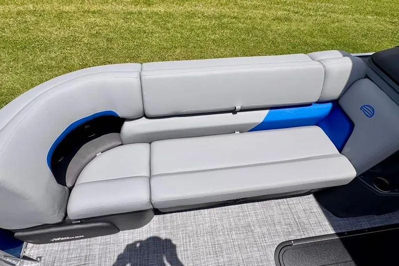 Slide: The Image of 2026 Sun Tracker Party Barge 22 XP3 seating, featuring gray and blue upholstery on a pontoon boat. - 16