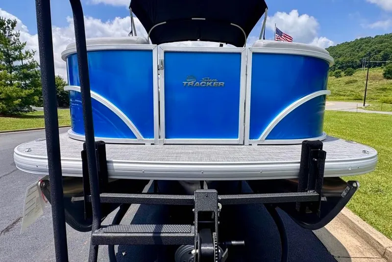 Slide: The Image of 2026 Sun Tracker Party Barge 22 XP3 pontoon boat on trailer, blue exterior. - 6