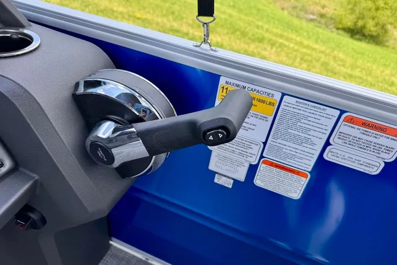 Slide: The Image of Throttle control and safety labels on a 2026 Sun Tracker Party Barge 22 XP3. - 7