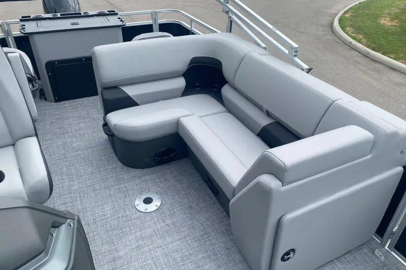 Slide: The Image of 2026 Sun Tracker SportFish 20 DLX pontoon boat interior with gray seating and flooring. - 9
