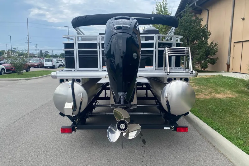 Slide: The Image of 2026 Sun Tracker SportFish 20 DLX pontoon boat with powerful outboard motor, parked outdoors. - 3