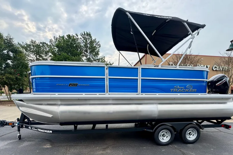 The Image of 2026 Sun Tracker Party Barge 20 DLX pontoon boat with canopy on trailer. - 0