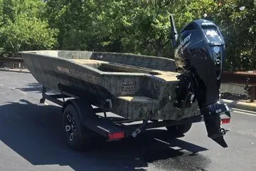 The Image of 2026 Tracker Grizzly 1756 T Marsh boat on trailer, parked outdoors. - 0