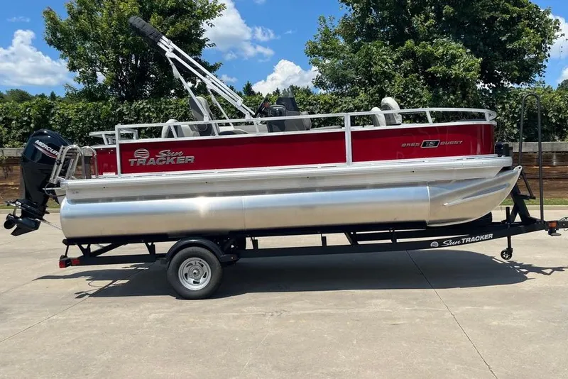 The Image of 2026 Sun Tracker Bass Buggy 18 DLX pontoon boat on trailer, parked outdoors. - 0