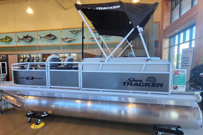 The Image of 2026 Sun Tracker Bass Buggy 16 XL Select pontoon boat displayed indoors. - 0