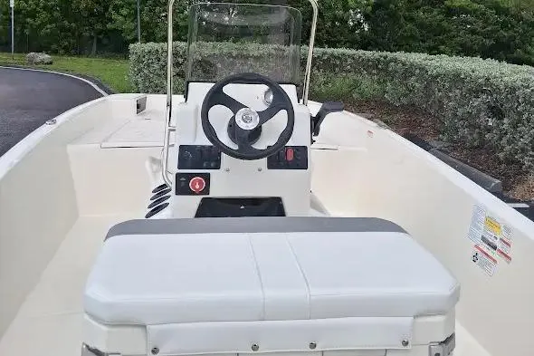 Slide: The Image of 2026 Mako Pro Skiff 17 CC boat interior with steering console and seating. - 4