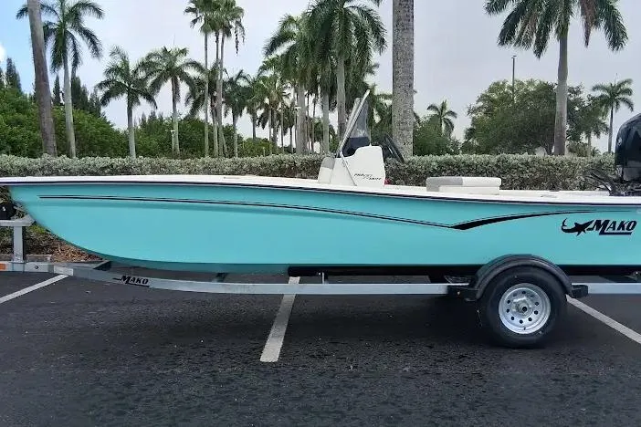 The Image of 2026 Mako Pro Skiff 17 CC boat on trailer, parked with palm trees in background. - 0