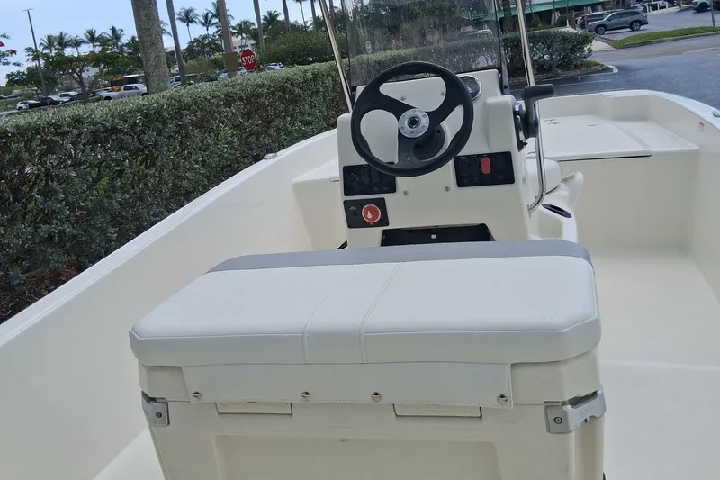 Slide: The Image of 2026 Mako Pro Skiff 17 CC boat interior with steering console and seating. - 5
