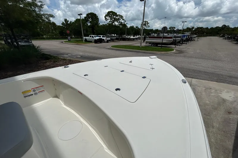 Slide: The Image of 2026 Mako 18 Pro Skiff boat parked in a marina under cloudy skies. - 4