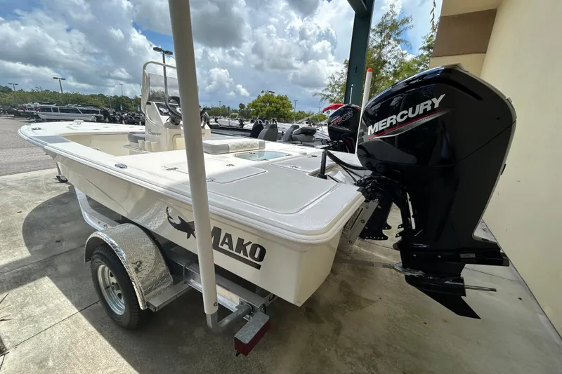 Slide: The Image of 2026 Mako 18 Pro Skiff boat with Mercury engine on trailer. - 1