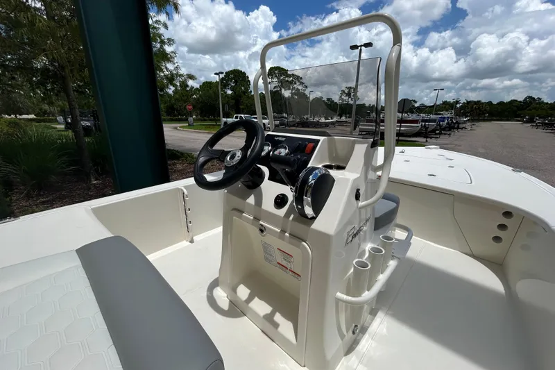 Slide: The Image of 2026 Mako 18 Pro Skiff boat interior with steering console and seating. - 7