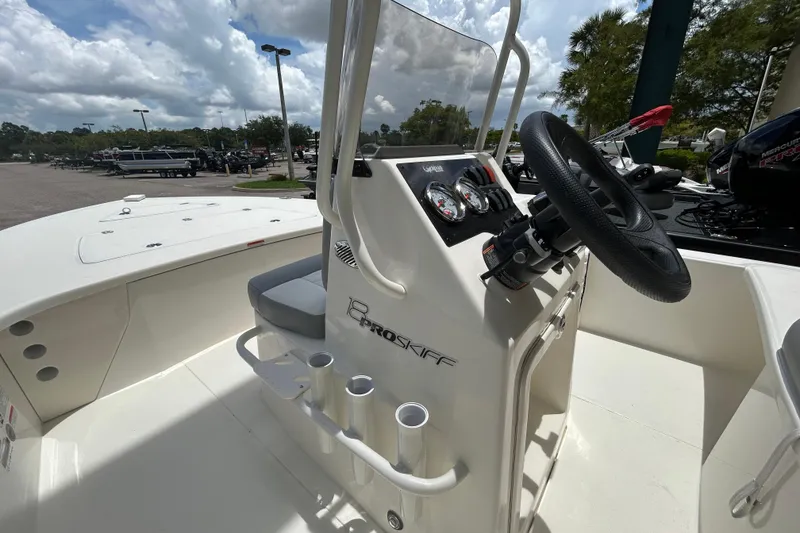 Slide: The Image of 2026 Mako 18 Pro Skiff boat interior with steering console and gauges. - 5