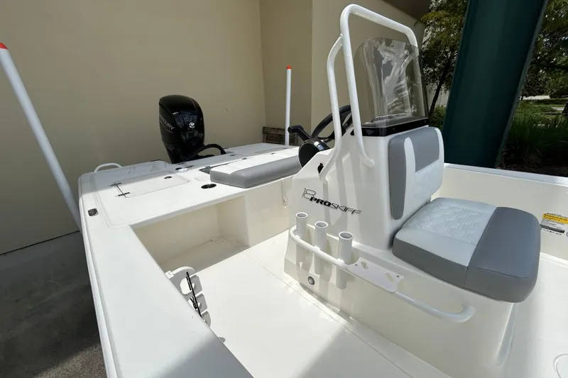 Slide: The Image of 2026 Mako 18 Pro Skiff boat interior with seating and steering console. - 6
