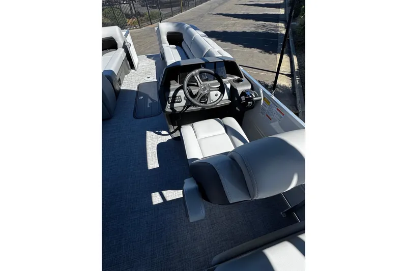 Slide: The Image of 2026 Sun Tracker Party Barge 24 XP3 interior with steering console and seating. - 5