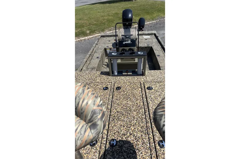Slide: The Image of 2026 Tracker Grizzly 2072 CC Sportsman Kicker boat interior with camo seats and control console. - 3