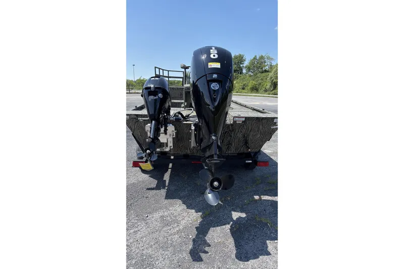 Slide: The Image of 2026 Tracker Grizzly 2072 CC Sportsman Kicker boat with dual outboard motors. - 4