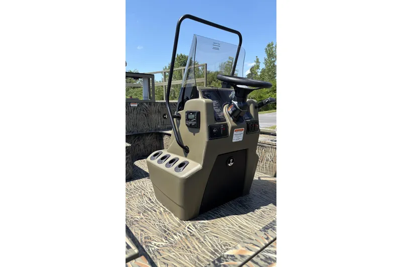 Slide: The Image of 2026 Tracker Grizzly 2072 CC Sportsman Kicker boat console with steering wheel and controls. - 2
