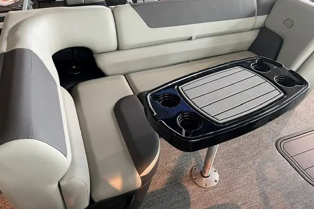 Slide: The Image of 2026 Sun Tracker Fishin' Barge 22 XP3 interior with seating and table, featuring cup holders. - 7