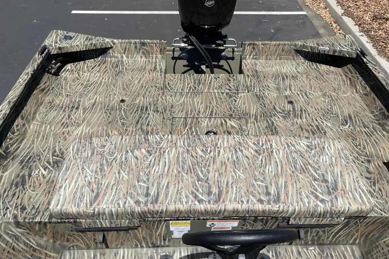 Slide: The Image of 2026 Tracker Grizzly 2072 CC boat with camouflage pattern in a parking lot. - 16