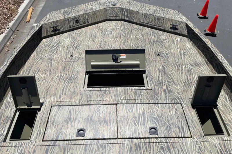 Slide: The Image of 2026 Tracker Grizzly 2072 CC boat deck with camo pattern and storage compartments. - 8