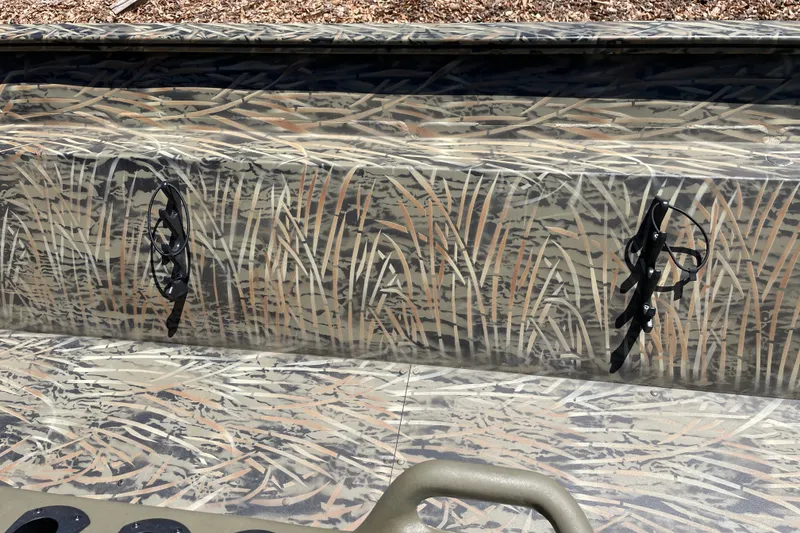 Slide: The Image of Camouflage-patterned Tracker Grizzly 2072 CC boat, 2026 model, with rod holders. - 10