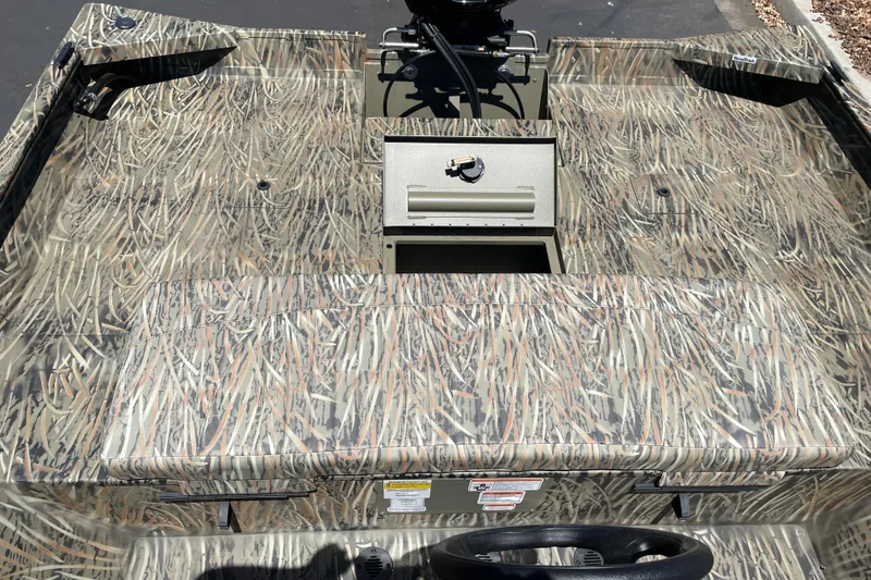Slide: The Image of 2026 Tracker Grizzly 2072 CC boat interior with camouflage pattern and steering wheel. - 15