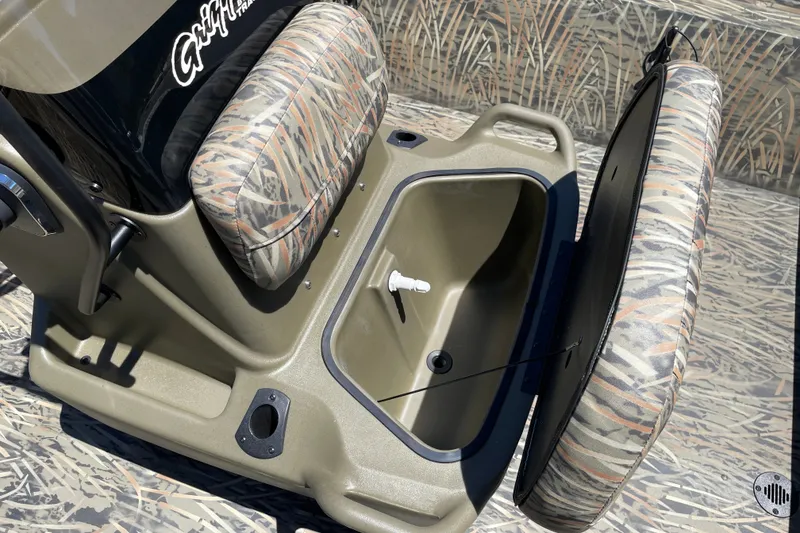 Slide: The Image of 2026 Tracker Grizzly 2072 CC boat seat with storage compartment, camo design. - 12