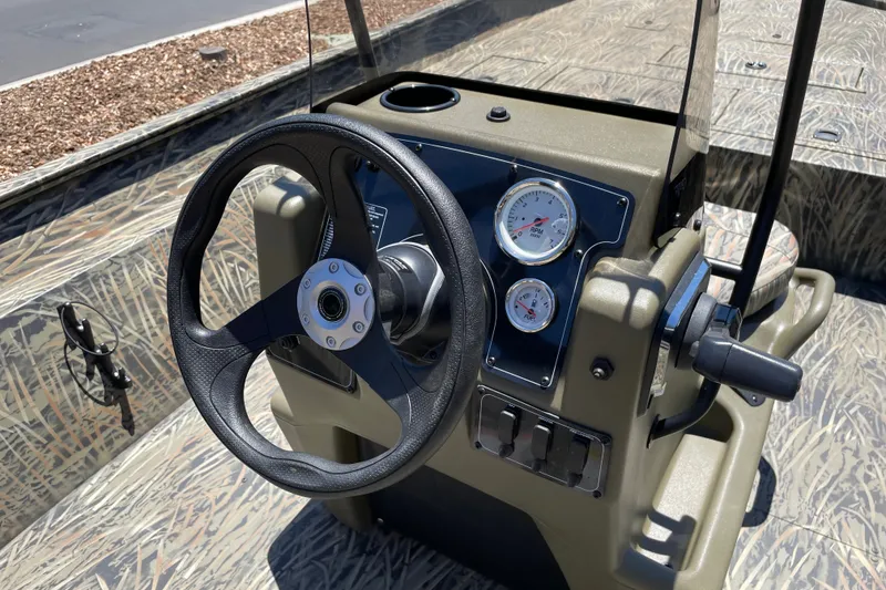 Slide: The Image of Steering console of 2026 Tracker Grizzly 2072 CC boat with gauges and controls. - 14