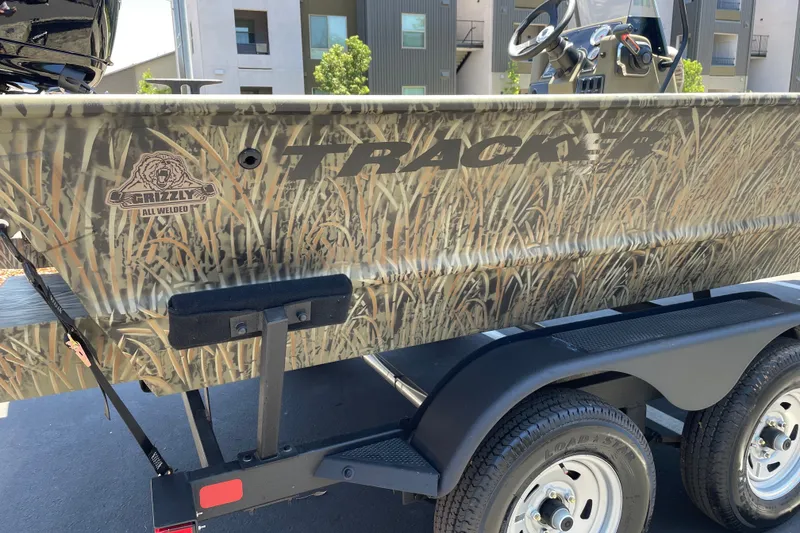 Slide: The Image of 2026 Tracker Grizzly 2072 CC boat with camouflage design on trailer. - 18