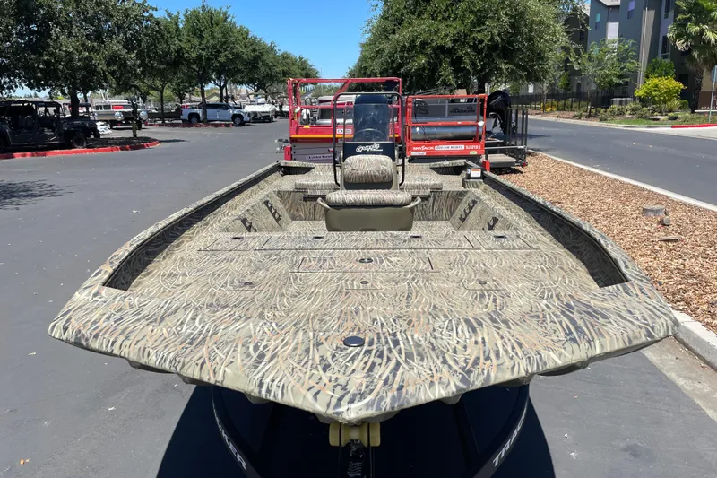 Slide: The Image of 2026 Tracker Grizzly 2072 CC boat with camouflage design parked outdoors. - 4