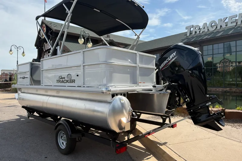 Slide: The Image of 2026 Sun Tracker Party Barge 18 DLX pontoon boat with Mercury engine on trailer. - 3