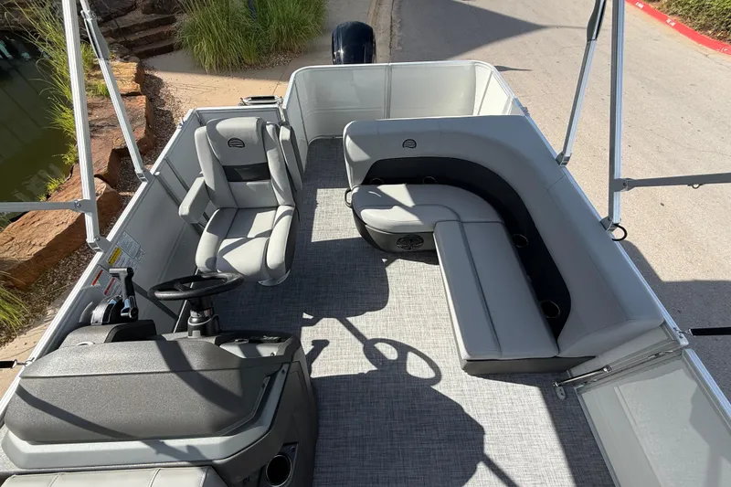 Slide: The Image of 2026 Sun Tracker Party Barge 18 DLX interior with seating and steering console. - 5