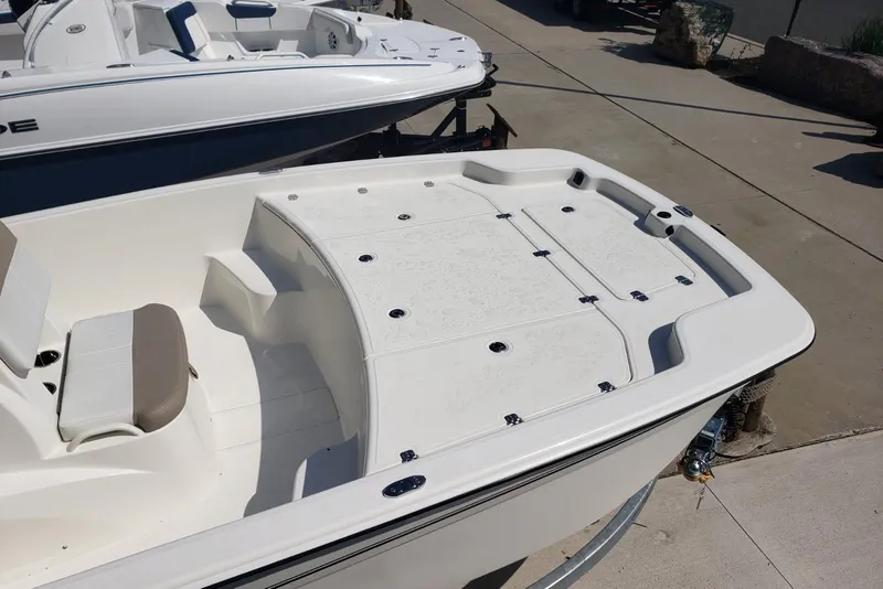 Slide: The Image of 2026 Mako Pro Skiff 19 CC boat, white deck, docked outdoors. - 8