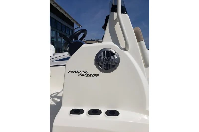 Slide: The Image of 2026 Mako Pro Skiff 19 CC boat console with steering wheel and speaker detail. - 9