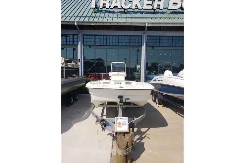 Slide: The Image of 2026 Mako Pro Skiff 19 CC displayed outside a Tracker Boats dealership. - 2