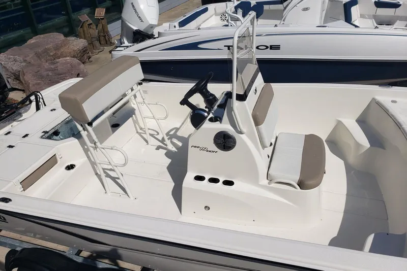 Slide: The Image of 2026 Mako Pro Skiff 19 CC boat interior with seating and steering console. - 6